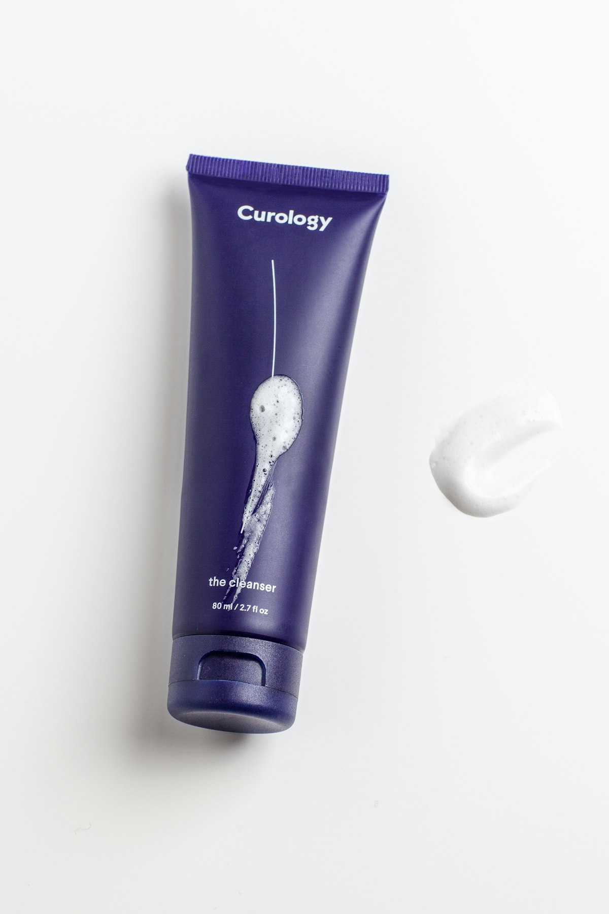 Minimal skincare bottle with dropper on beige background